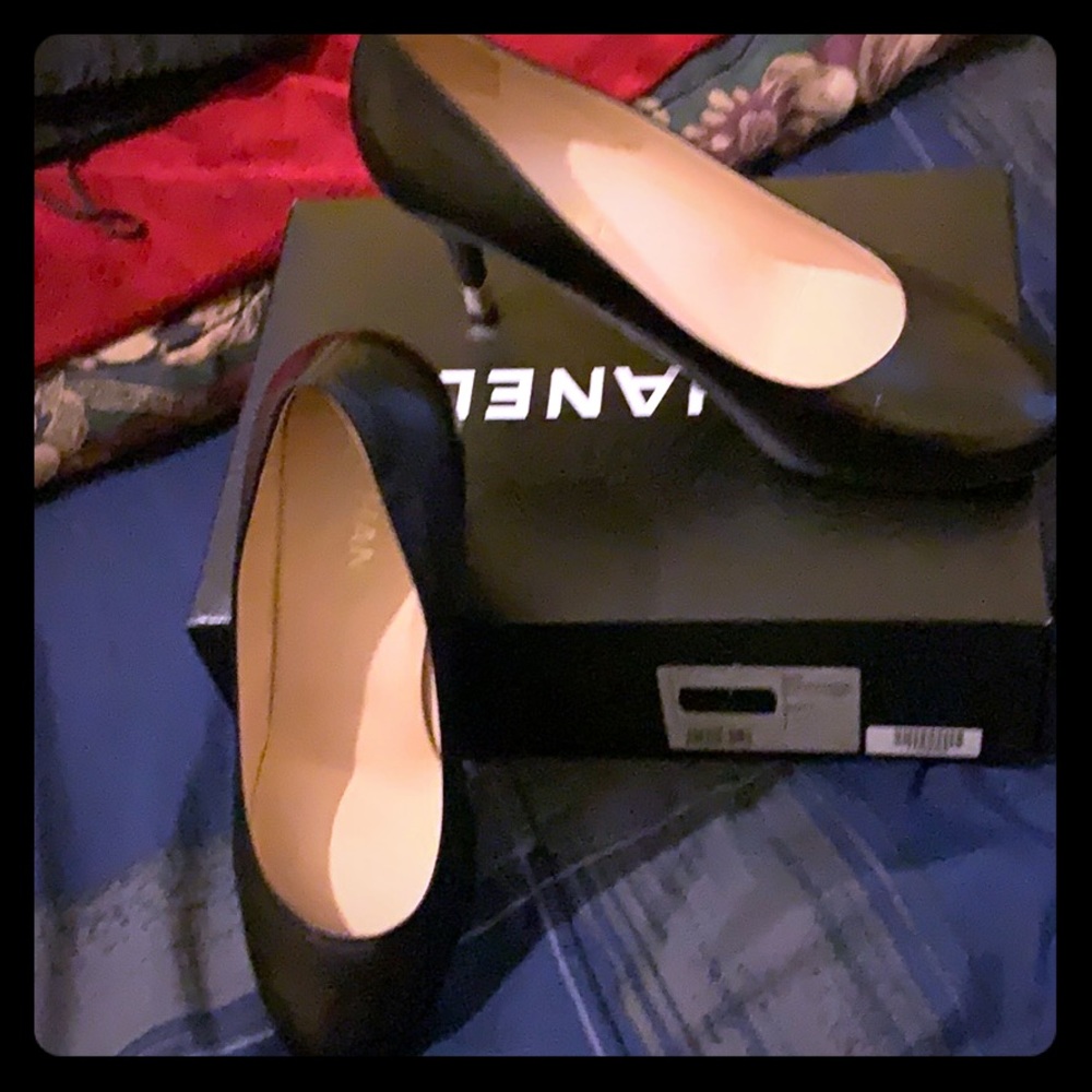 Channel black leather pumps.